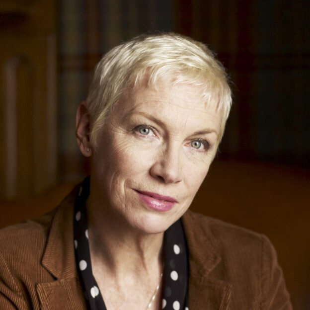 The singer Annie Lennox, founder of The Circle looks directly out of the frame with a slight smile. 